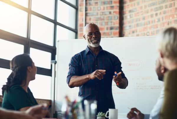 Senior salesman hosting Medicare compliant meeting for group of women