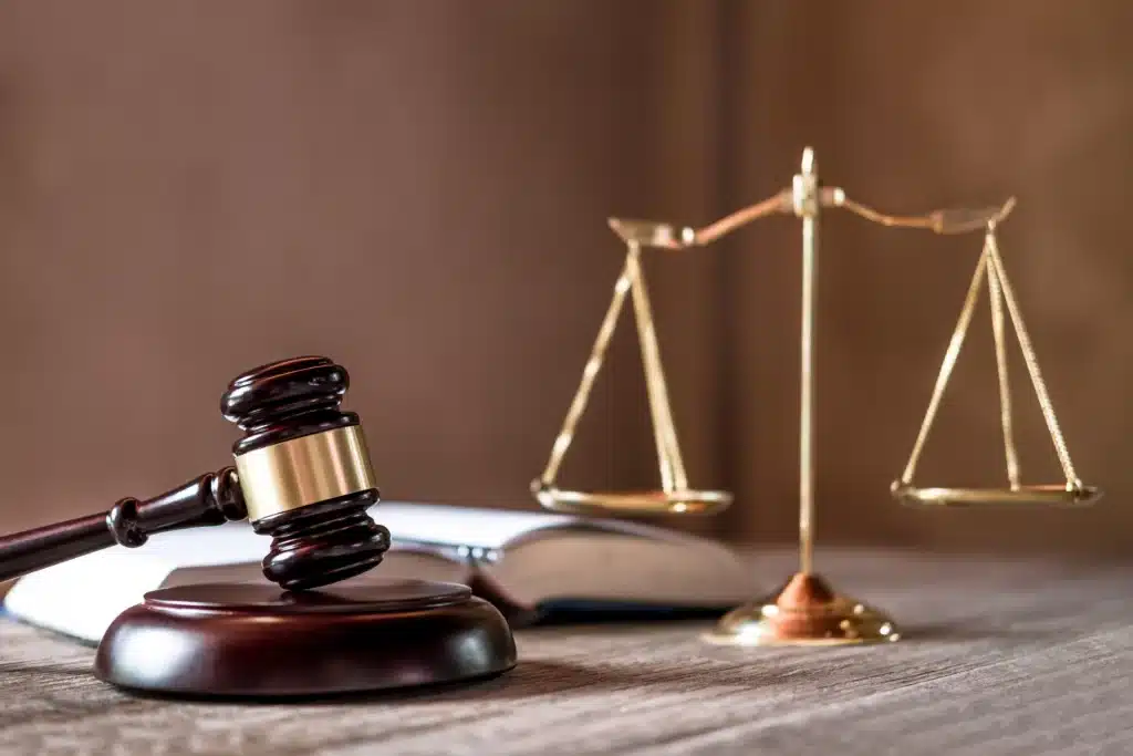 brown gavel and gold scale on a table